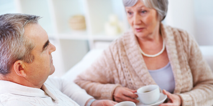 Couple With Coffee Cups Having a Serious Conversation 