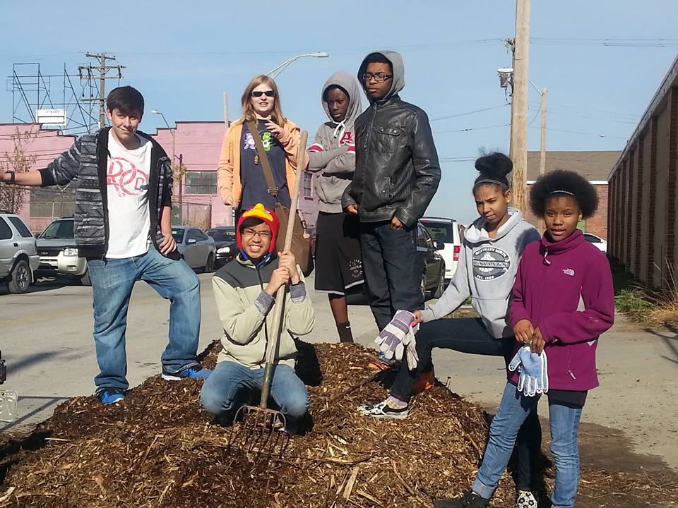 Several Green Works students spreading mulch.