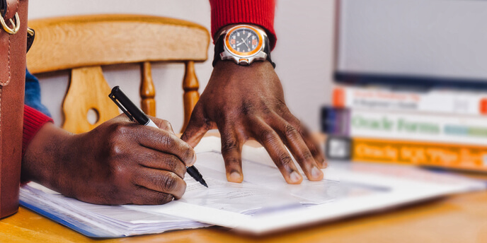 Image of a Person Writing on Labels