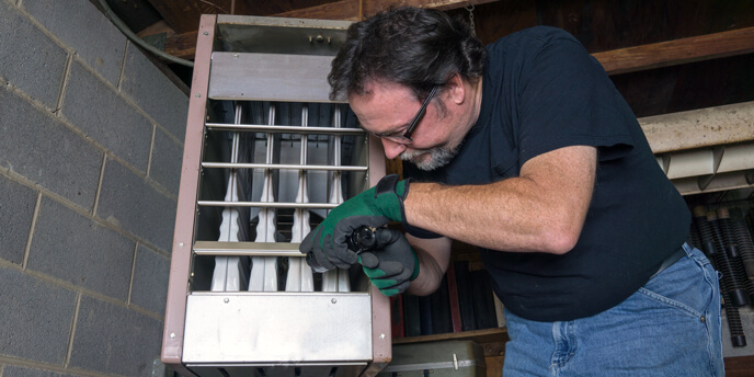 Professional Wearing Goggles and Gloves Inspecting Furnace