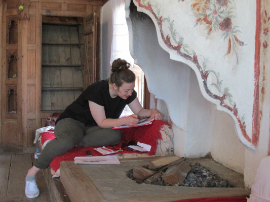 Volunteer preserving a historic fireplace.