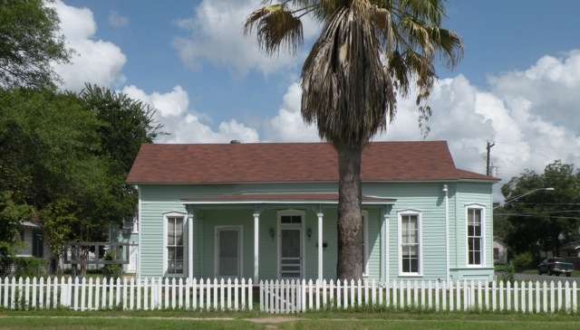 A modest, light blue historic home in Austin.