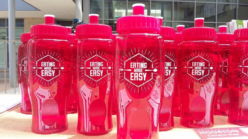 Red Reusable Water Bottles that say "Eating Made Easy"