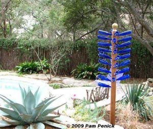 Blue Bottles on a Wooden Frame.