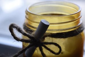 A Glass Jar With a Twine bow, Reused as a Candle Holder.