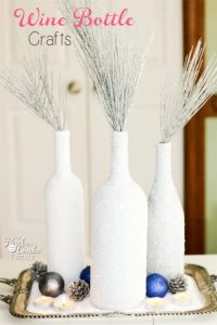 Reused Bottles Painted White and Filled With Winter Foliage.