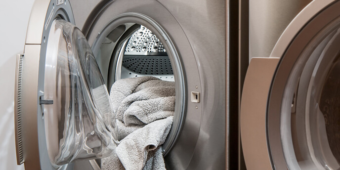 Towel Hanging out of Open Washing Machine