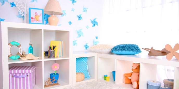 Bright Playroom with White Walls and Open Shelves Containing Children’s Toys