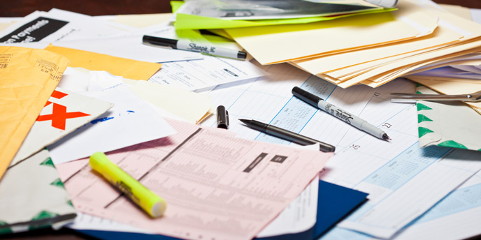 Bills, Receipts and Important Papers on a Messy Desk