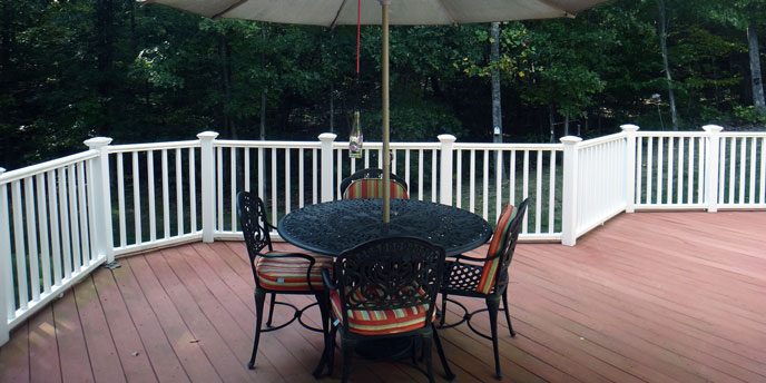 Backyard Deck With White Guardrails and Summer Patio Furniture