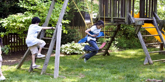 Children Playing on Wooden Swingset