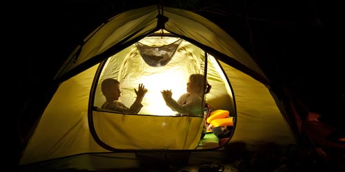 Two Kids Inside Tent Making Shadow Puppets