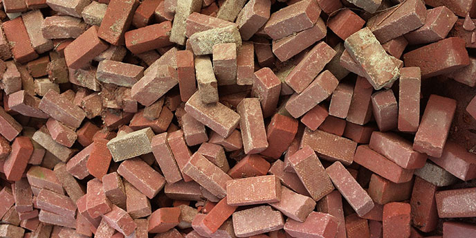 Large, Jumbled Pile of Red Bricks