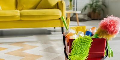 Bucket of Cleaning Supplies in Living Room