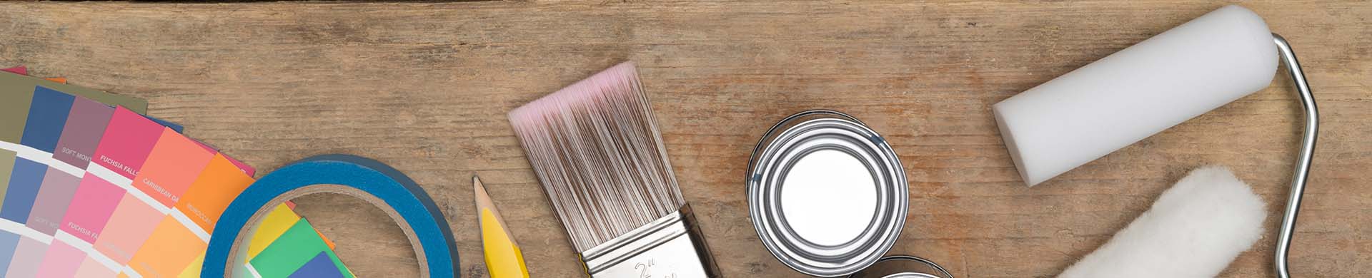 Painting Tools and Supplies Against Wooden Background