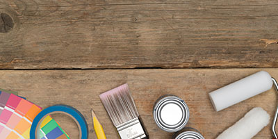 Painting Tools and Supplies Against Wooden Background
