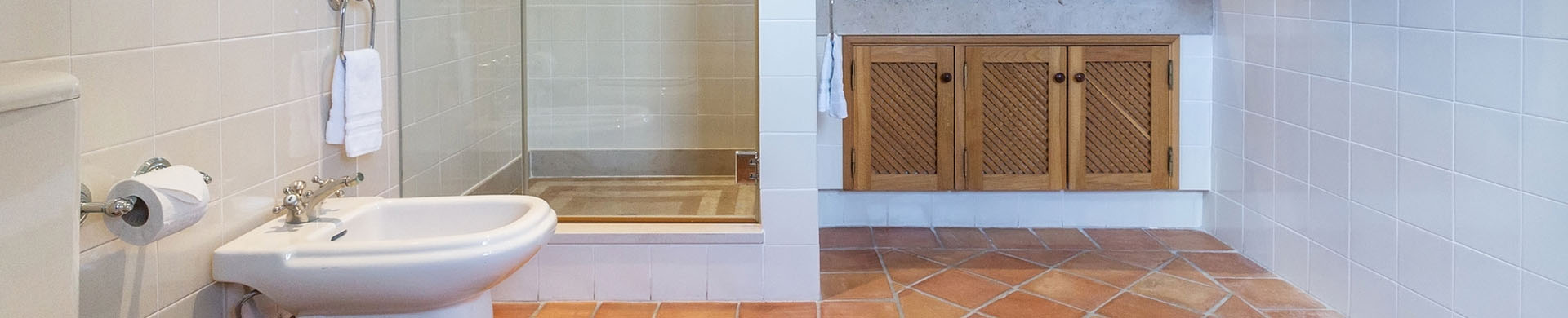 Modern Bathroom With White Tiled Walls and Brown Tiled Floor