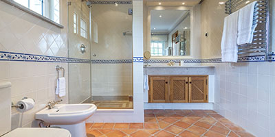 Modern Bathroom With White Tiled Walls and Brown Tiled Floor