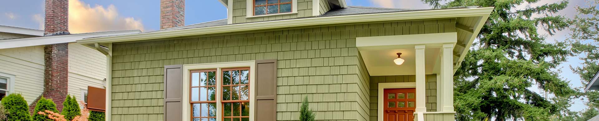 Green House with Front Yard and Shrubs