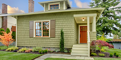 Green House with Front Yard and Shrubs