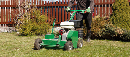 Man Using Lawn Aerator