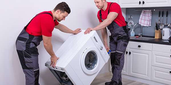 Two Salvation Army Delivery Workers Moving a Washing Machine.