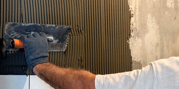 Man Applying Mortar with Notched Trowel