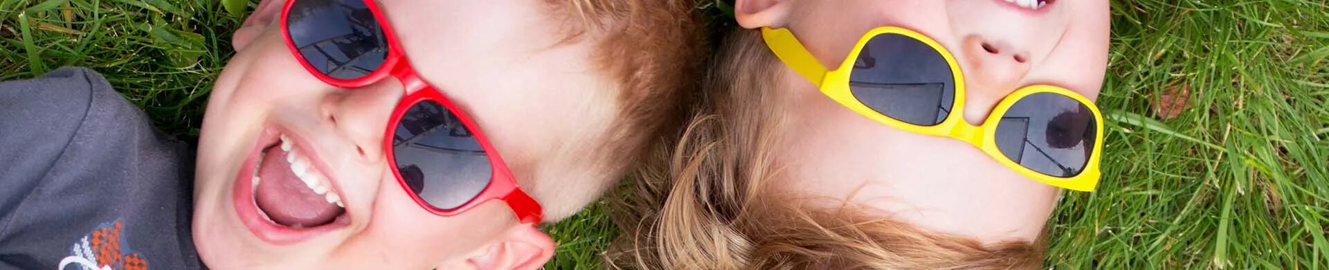 Kids Playing Outdoors with Colorful Sunglasses On