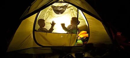 Two Kids Inside Tent Making Shadow Puppets
