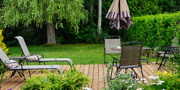 Backyard Wooden Deck With Chairs and Umbrella