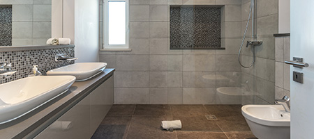 Bathroom With Brown Tile Going Into the Shower