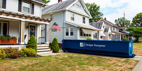 Blue Budget Dumpster Dumpster in Driveway