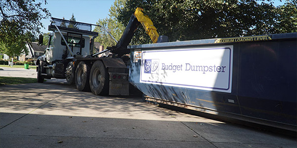 Truck Hauling Blue Budget Dumpster Dumpster