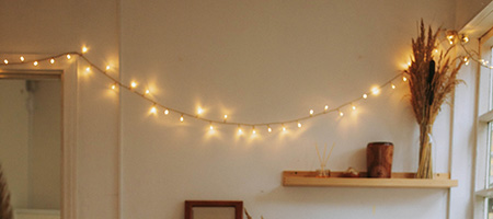 Fairy String Lights Draped Across Bedroom Wall