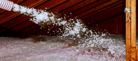 Blown- In Insulation Being Sprayed into Attic.