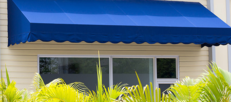 Blue Awning Above a Window Keeping Sun Out