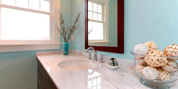 Blue Bathroom With White Marble Counter Top