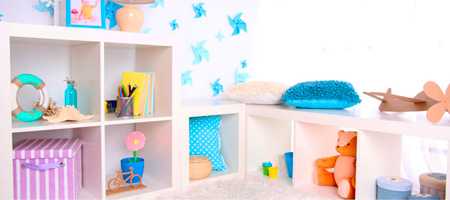 Bright Playroom with White Walls and Open Shelves Containing Children’s Toys