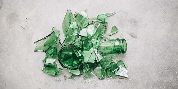 Broken Green Glass on Gray Background