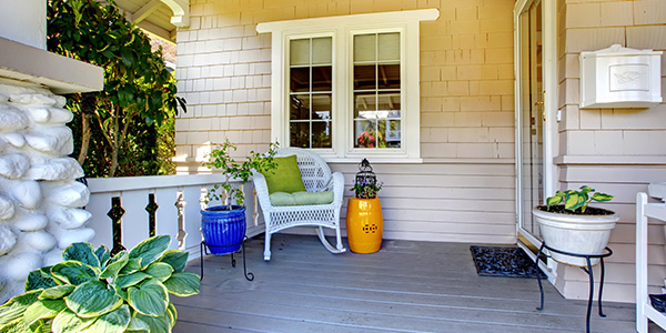Potted Plants and White Mailbox on Wooden Front Porch