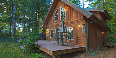 Cabin in a Wooded Area, With a Rustic Log or Wooden Exterior, in a Peaceful, Serene Setting.