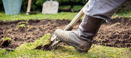 Homeowner Wearing Boots to Dig Grass and Soil