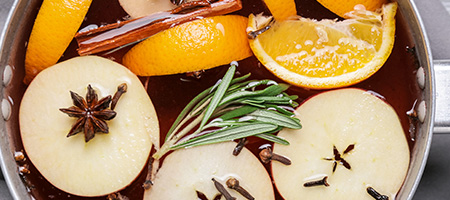 Apples, Oranges, Spices and Herbs Simmering in Pot