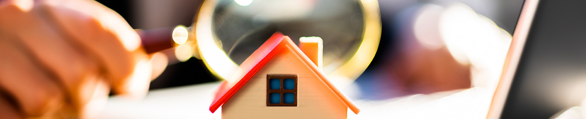 Inspecting Miniature House With Magnifying Glass for Code Violations