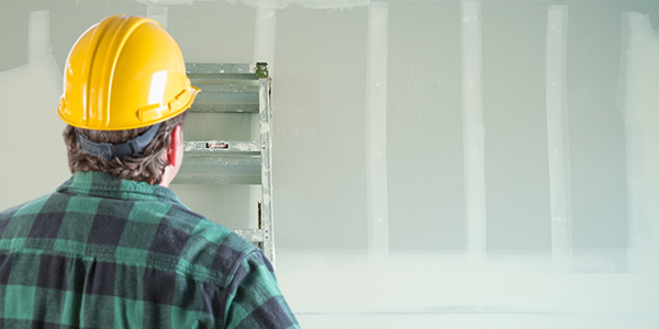 Contractor Looking at Wall