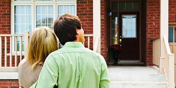 Couple Standing in Front of New Home