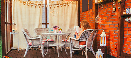 Cozy Backyard Deck with Curtains