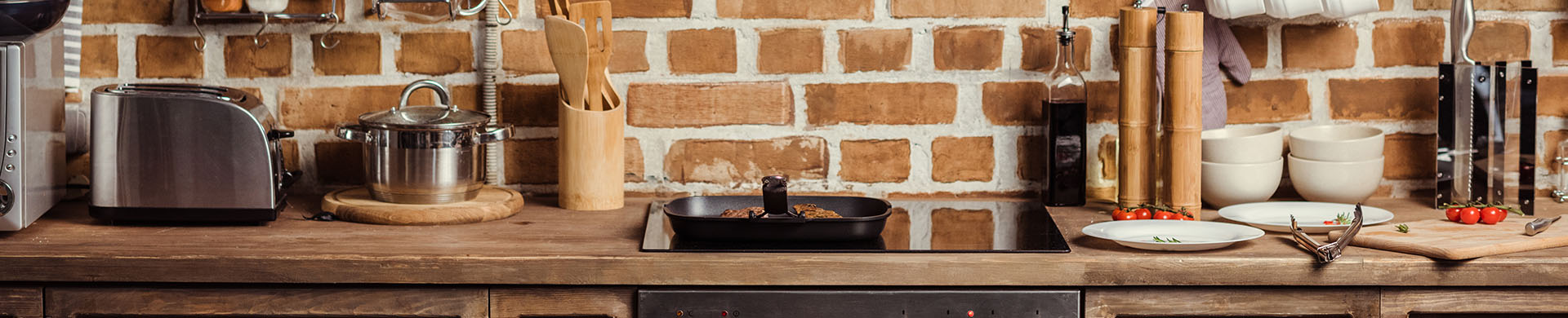 Brick Kitchen with White Pottery and Cluttered Countertops