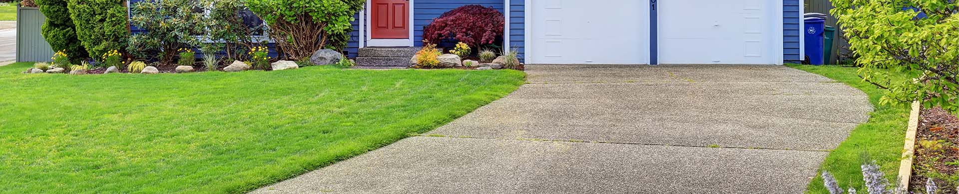 Concrete Driveway Leading Up to Two-Car Garage