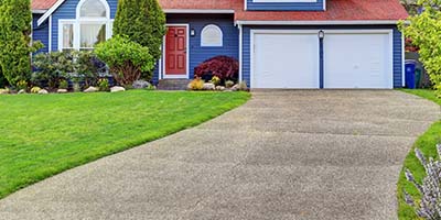 Concrete Driveway Leading Up to Two-Car Garage